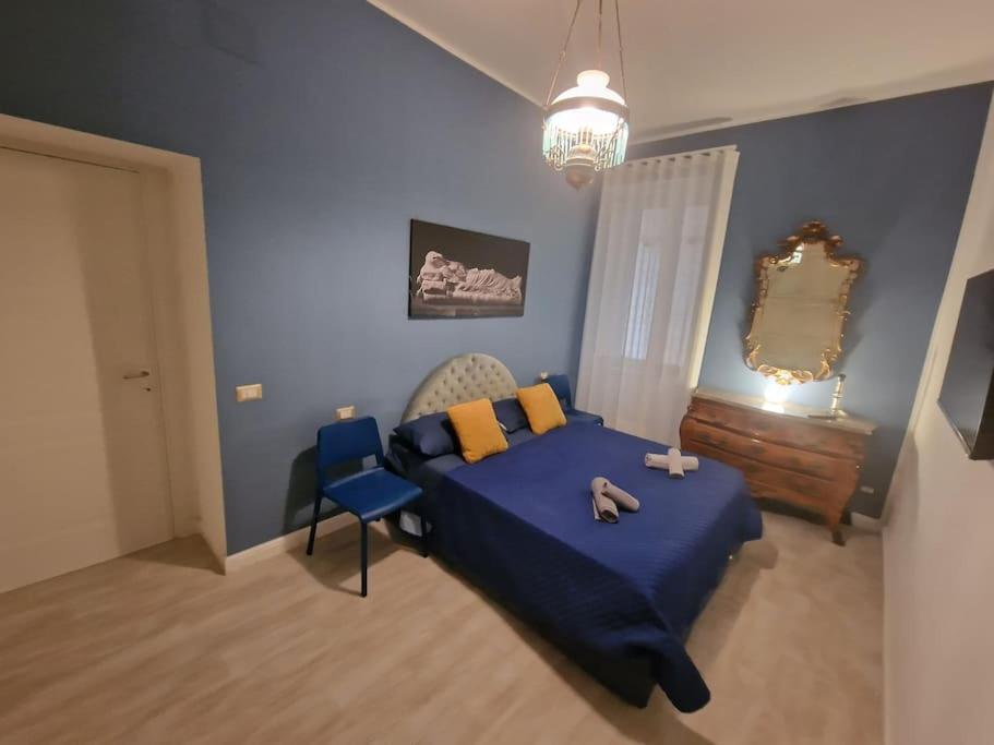 a bedroom with a bed with a teddy bear on it at Pastel blue house x 5 people in Corso above metro Montesanto in Naples