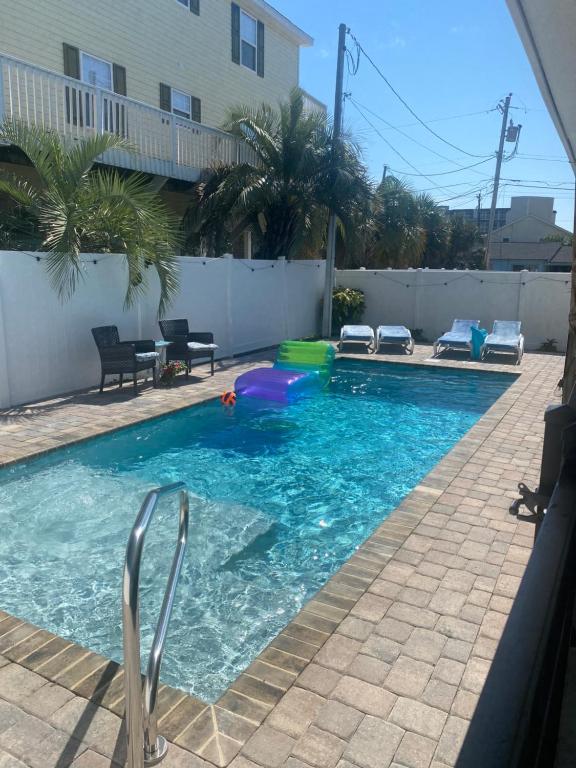 a swimming pool with a ball in the water at Beach Breeze 1, short walk to Atlantic Ocean, pet friendly, very quiet & family friendly in Myrtle Beach