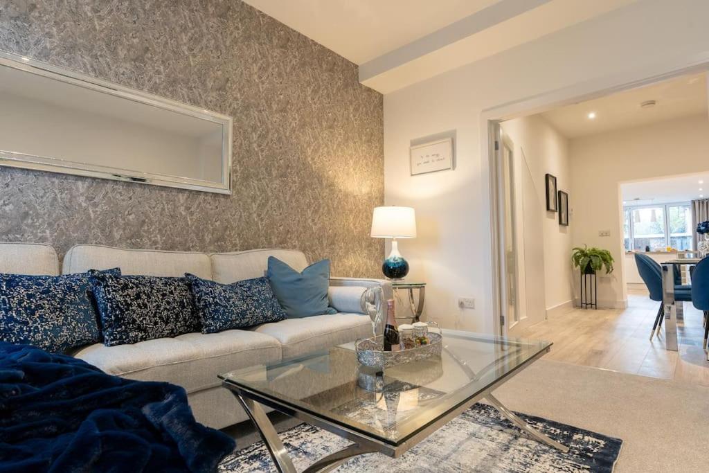 uma sala de estar com um sofá e uma mesa de vidro em Luxury living away from home em Earlswood