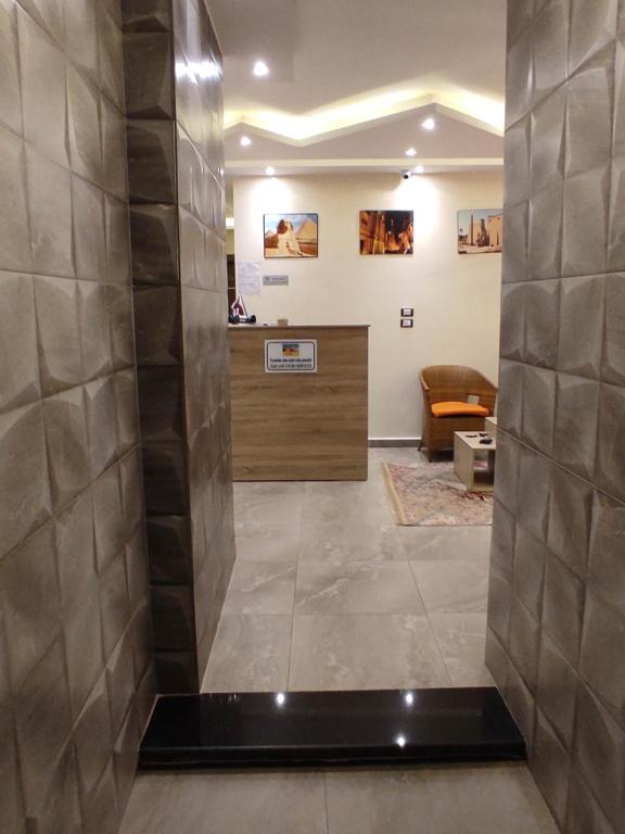 a lobby with a reception desk in a building at pyramids view suite/vista piramidi in Cairo
