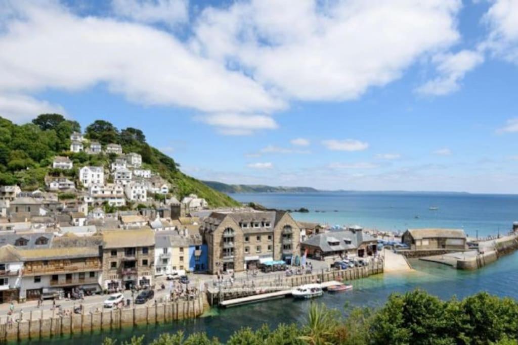 a town on a hill next to the water at Rame in Looe