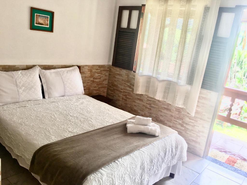 Ein Bett oder Betten in einem Zimmer der Unterkunft Chácara kiwi
