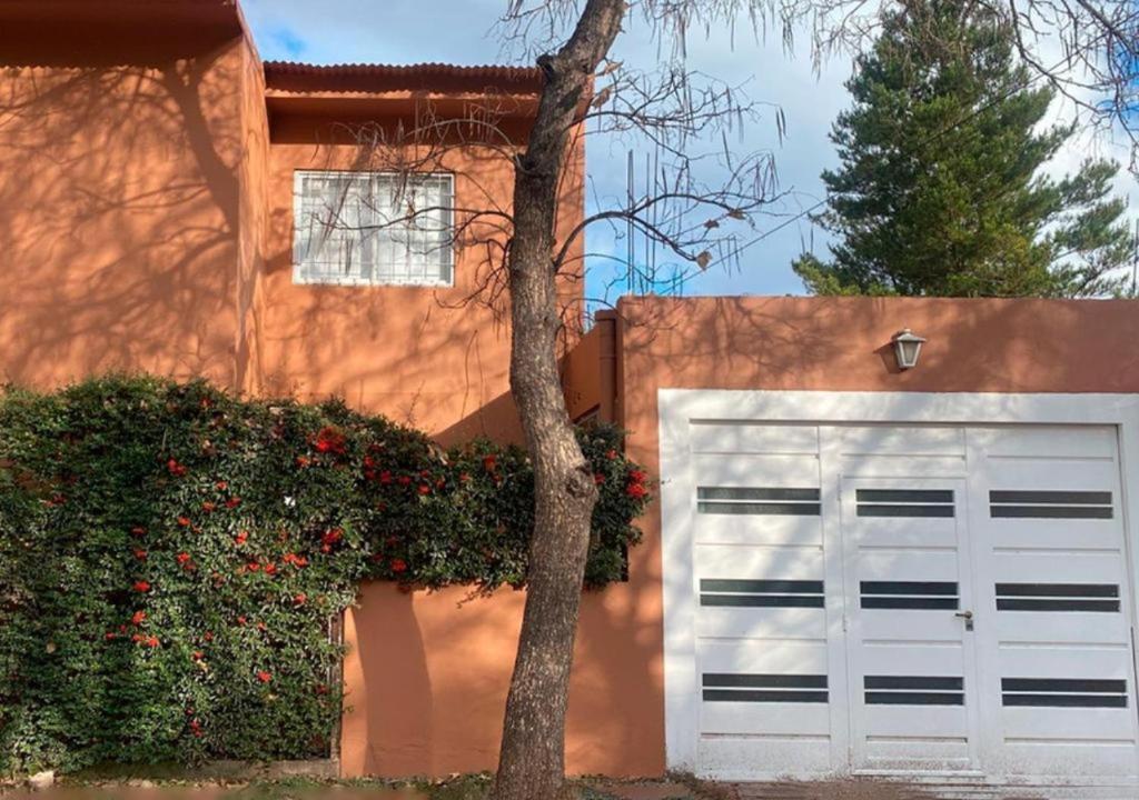 a white garage door in front of a house at Casa POTRERO DE LOS FUNES 2025-2026 in Potrero de los Funes