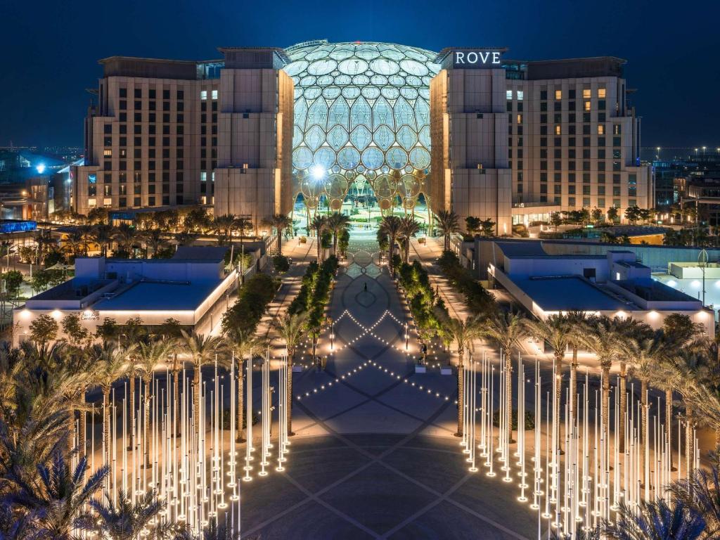 a view of the royal palm hotel at night at Rove Expo City in Dubai