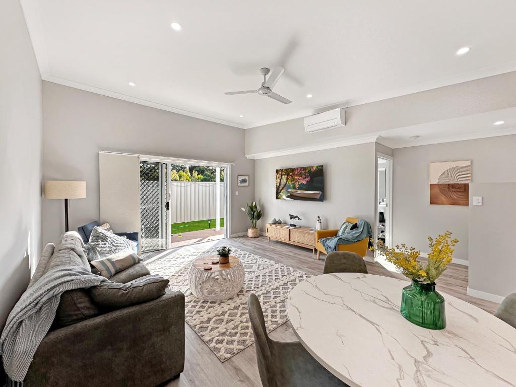 a living room with a table and a couch at Family-friendly Seaside Gem in Urangan