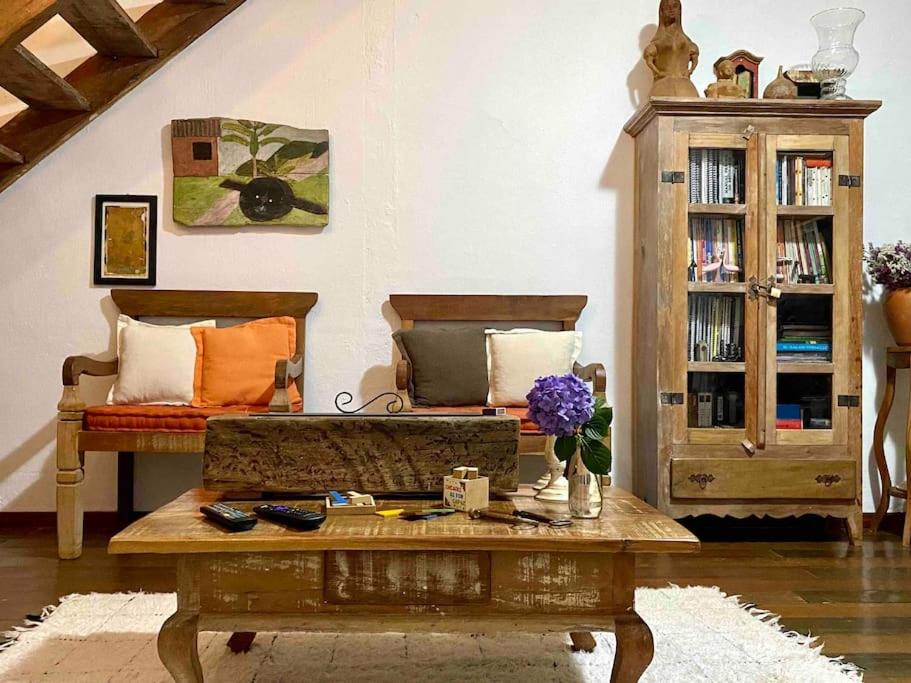 a living room with two beds and a coffee table at Cantinho Almeida in Tiradentes