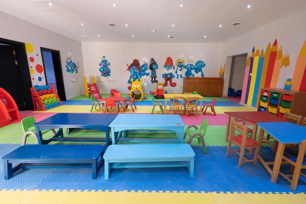 a classroom with tables and chairs in a play room at Parrotel Lagoon Waterpark Resort in Sharm El Sheikh