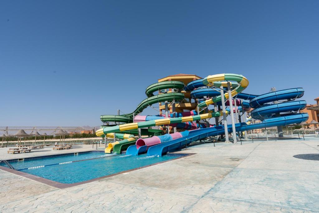 a water slide at a water park with a pool at Parrotel Lagoon Waterpark Resort in Sharm El Sheikh