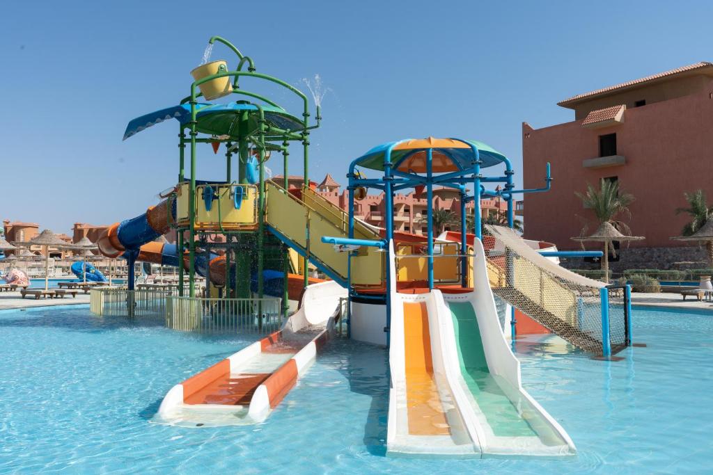 a water park with two slides in the water at Parrotel Lagoon Waterpark Resort in Sharm El Sheikh