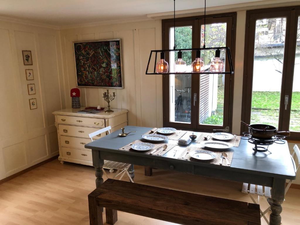 a dining room with a table and a chandelier at Simple Appartment in the Center of Burgdorf 64 m2 with private Parking - SMALL BATHROOM in Burgdorf