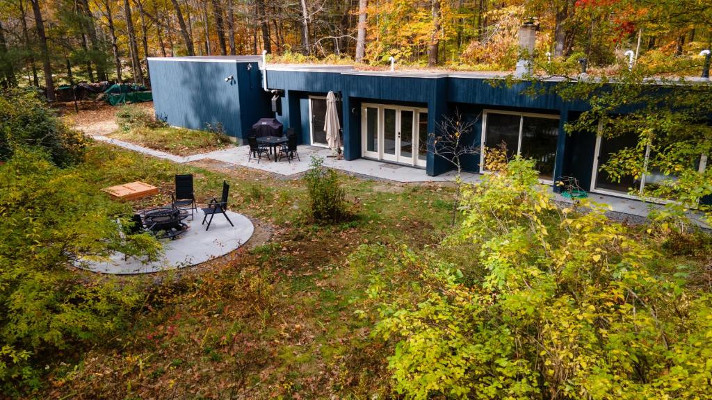an aerial view of a house in the woods at earthship forest exile 