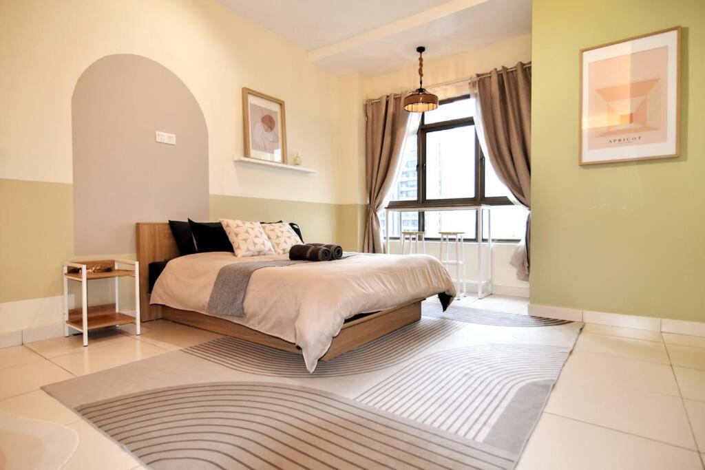 een slaapkamer met een bed en een groot raam bij KL Art Nouveau Suite, MRT, Free Parking, Self Check In in Petaling Jaya