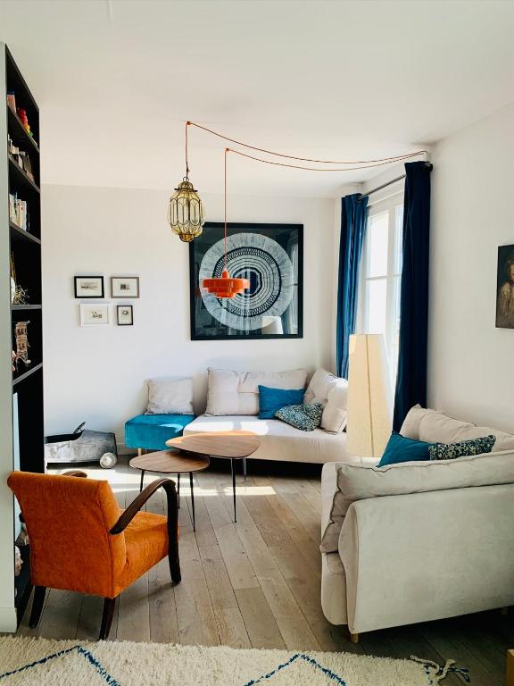 un salon avec un canapé et une table dans l'établissement Place des Vosges, à Paris