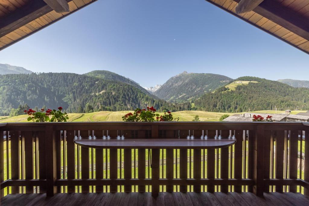 a view from the deck of a house with mountains in the background at Apartmenthaus - Erlebenswert Bauernhof Gruber in Sankt Lorenzen im Lesachtal