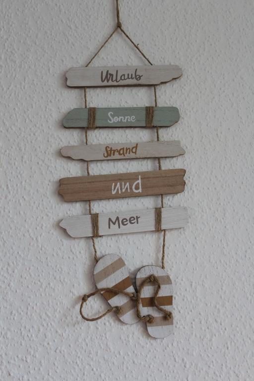a group of signs hanging on a wall at Urlaub im Herzen von Laboe in Laboe