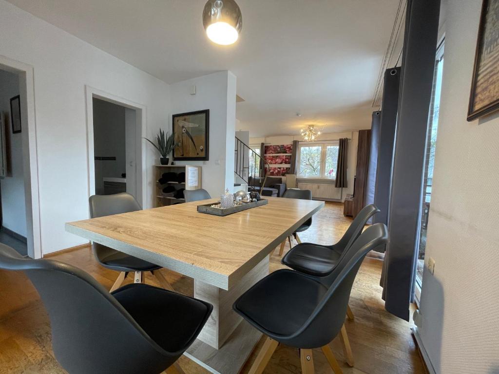 a dining room with a wooden table and chairs at Fewo Zentral in Willingen