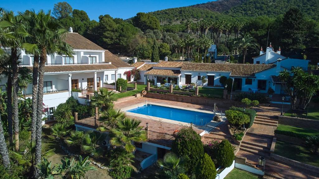 an aerial view of a house with a swimming pool at Hotel Alhaurín Golf Resort in Alhaurín el Grande