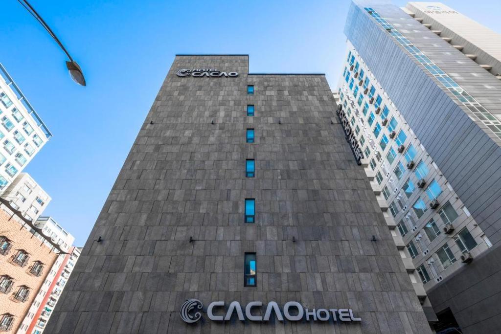 a tall building with the cisco hotel on it at Cacao Hotel in Incheon