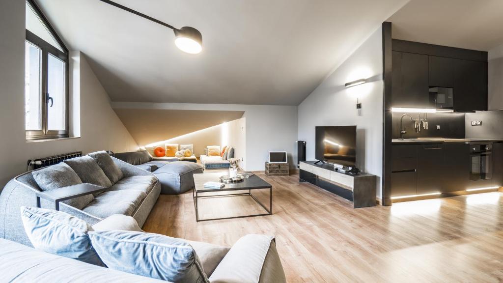 a living room with a couch and a table at KOKONO Vacation Rental Apartment El Tarter, Andorra in El Tarter