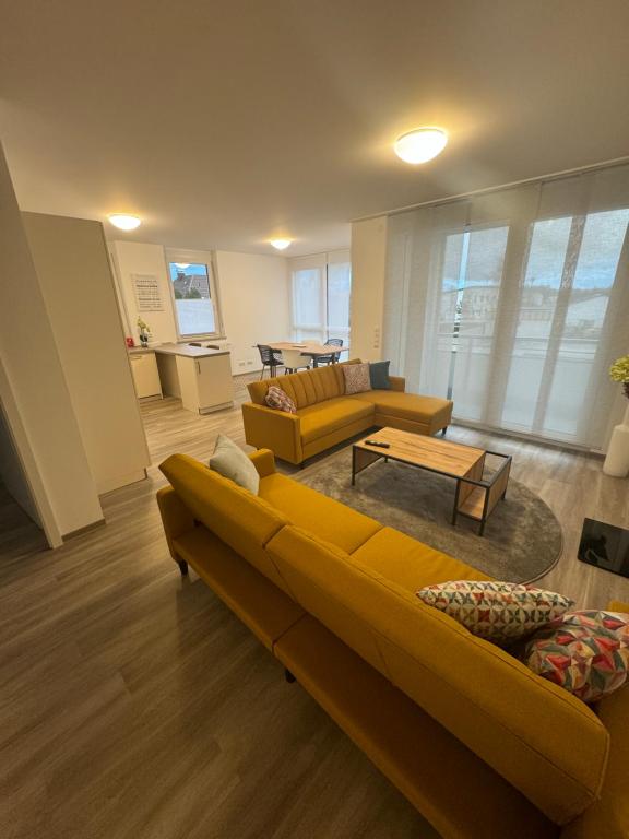 a living room with a couch and a table at to be apartments Deluxe-Suites in Weiden