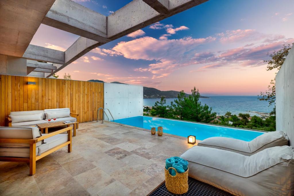 an outdoor patio with a view of the ocean at THESIS VILLAS in Skala Potamias