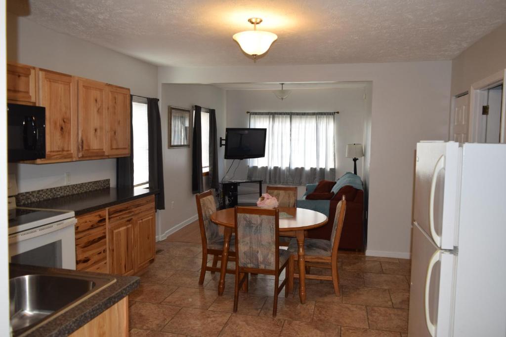 a kitchen with a table and a white refrigerator at Cattaraugus, Your home away from home! in Cattaraugus