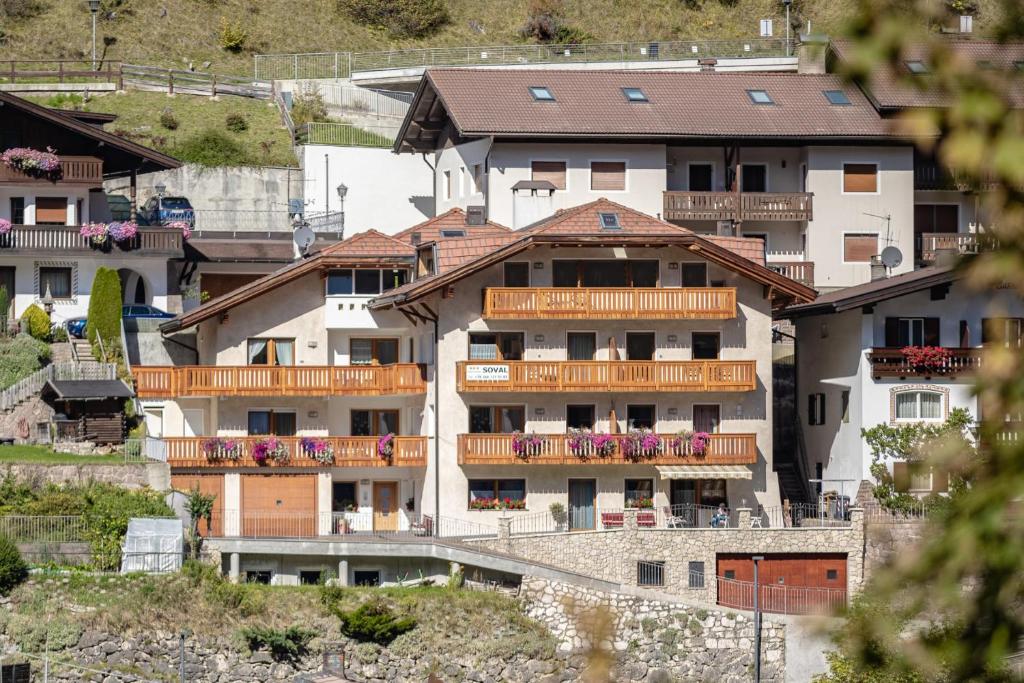 a group of apartment buildings on a hill at Apartments Soval in Santa Cristina in Val Gardena