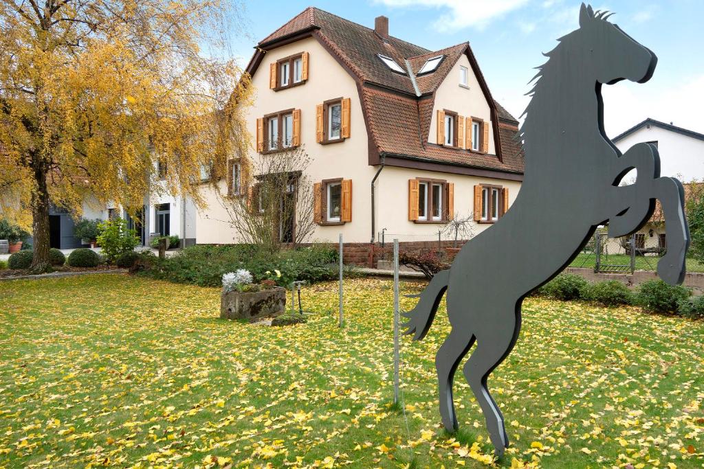 a statue of a horse in front of a house at Goldberg in Grünstadt