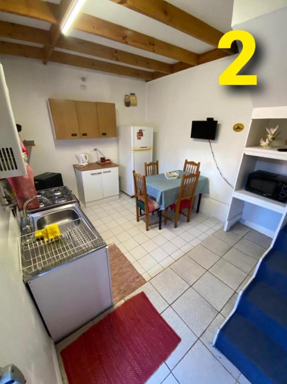 a kitchen and living room with a table and a kitchen and a dining room at Departamentos Puerto Montt in Puerto Montt