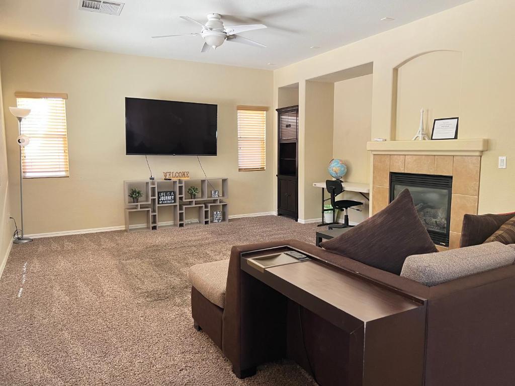 a living room with a couch and a tv at Peaceful Oasis 4 bedroom in Summerlin close to Redrock in Las Vegas