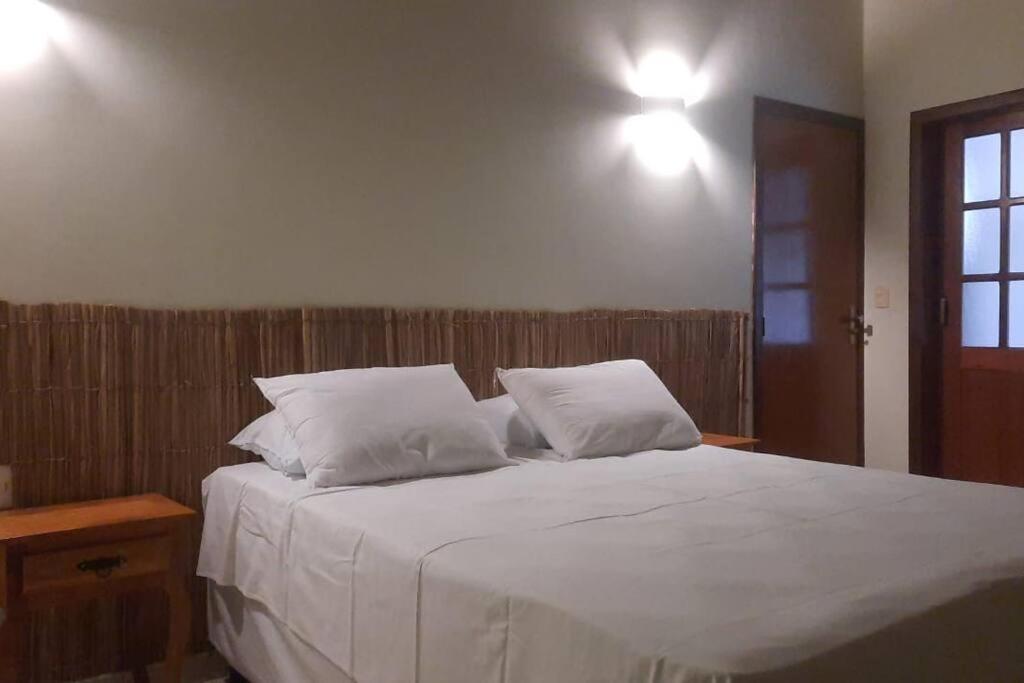 Postel nebo postele na pokoji v ubytování Casa Pequizeiro