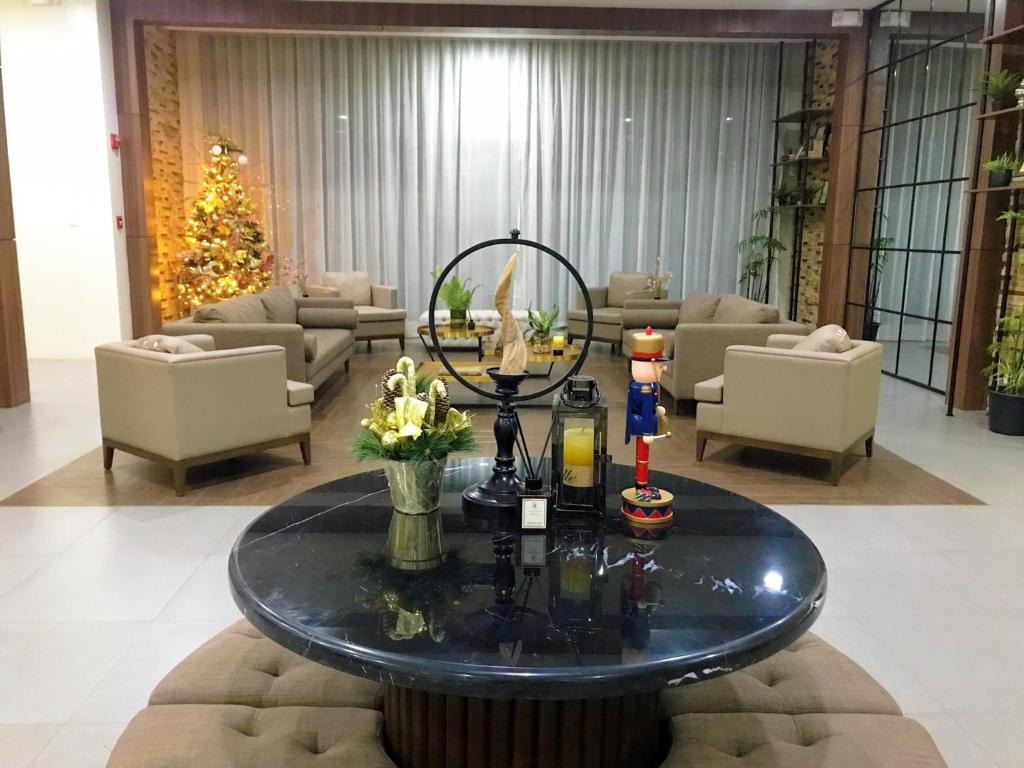 a lobby with a table with flowers on it at Brenthill Condominium in Baguio