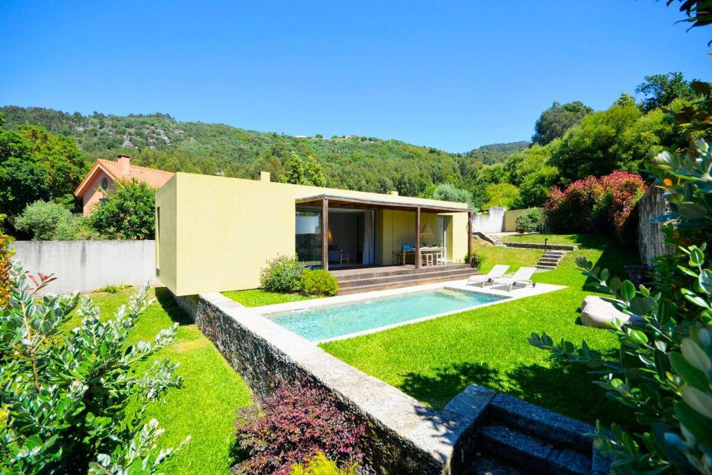 a house with a swimming pool in a yard at Villa 292 in Caminha