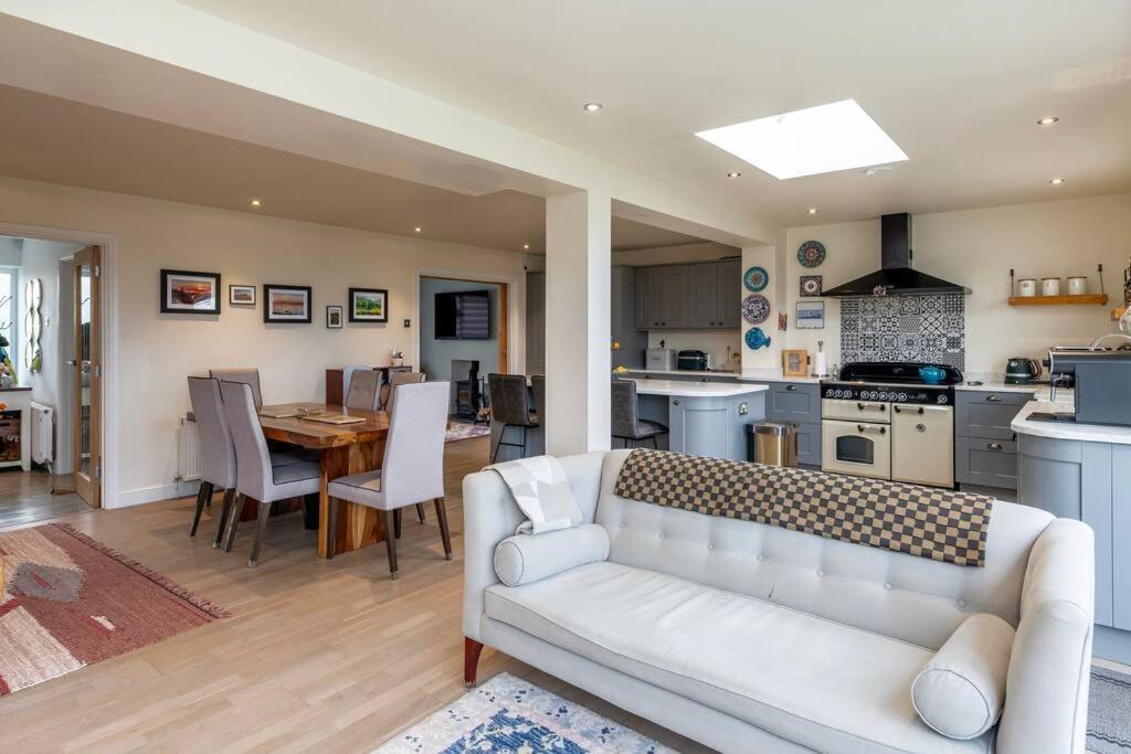 a living room with a white couch and a kitchen at Fabulous House in Bath w/parking in Bath