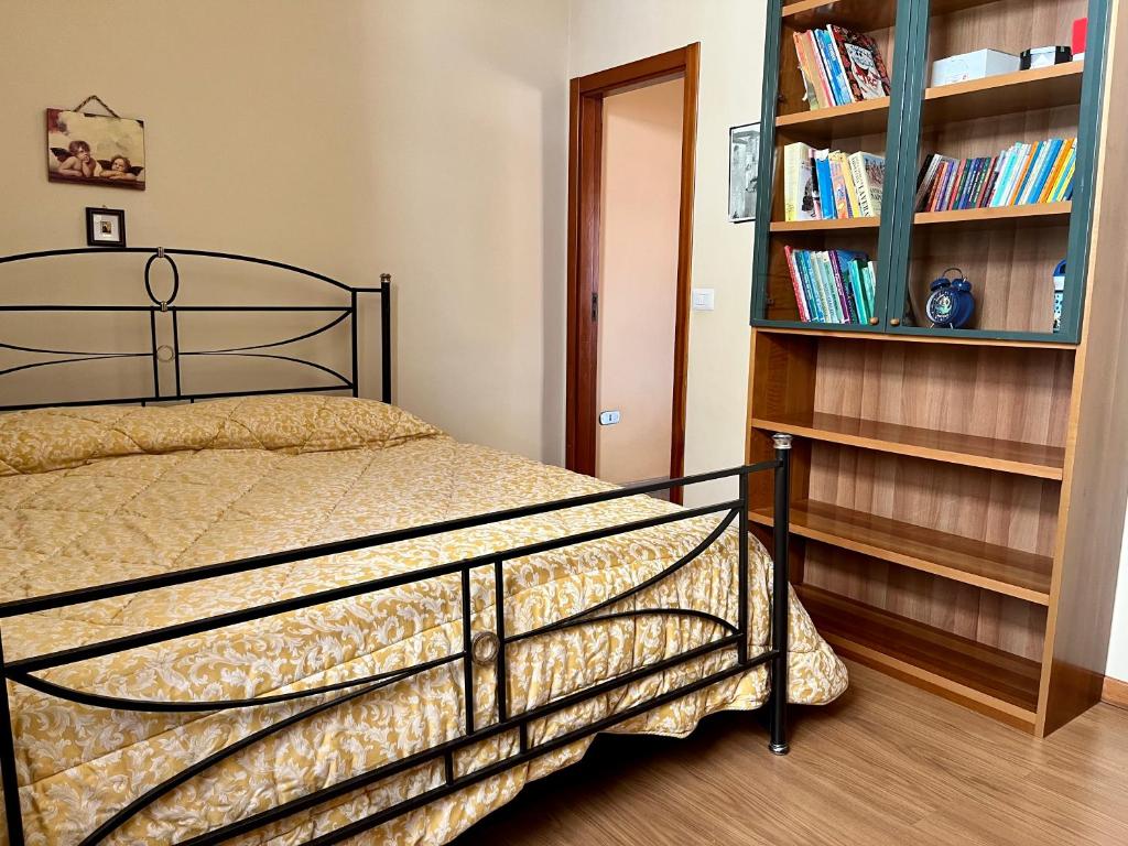 a bedroom with a bed and a book shelf at La Panchina sul Corso in Grassano