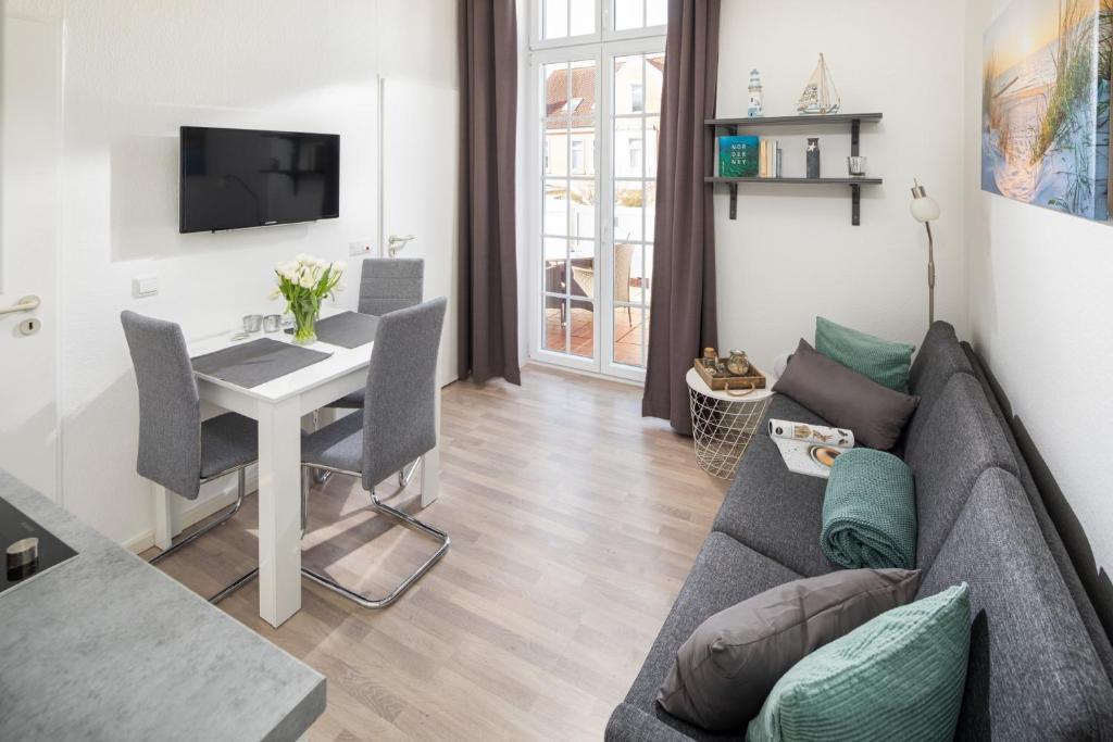 a living room with a couch and a table at Haus Bielefeld Ferienwohnung 10 in Norderney