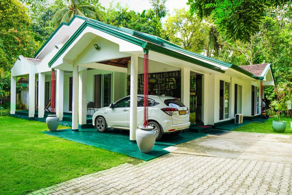 a car parked in front of a house at Villa Nadya Guesthouse in Pilana