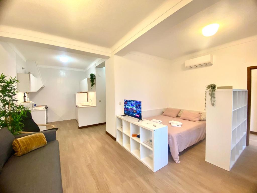 a small room with a bed and a couch at Ericeira Panoramic Sea View Apartments in Ericeira