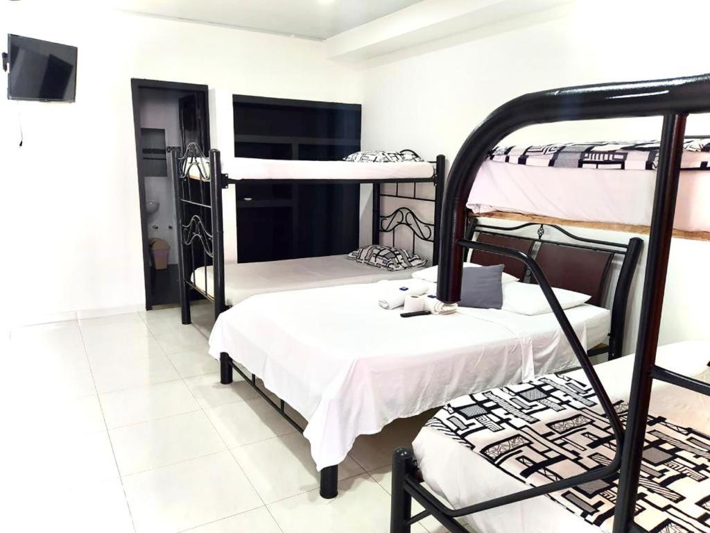 a dorm room with two bunk beds in it at Hotel Tradicional Villeta in Villeta