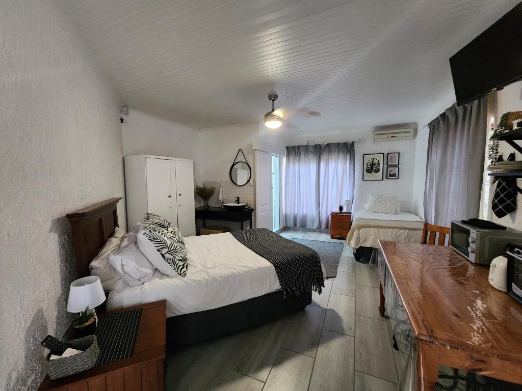 a bedroom with a bed and a television in it at Groenewald's Haven in Nelspruit