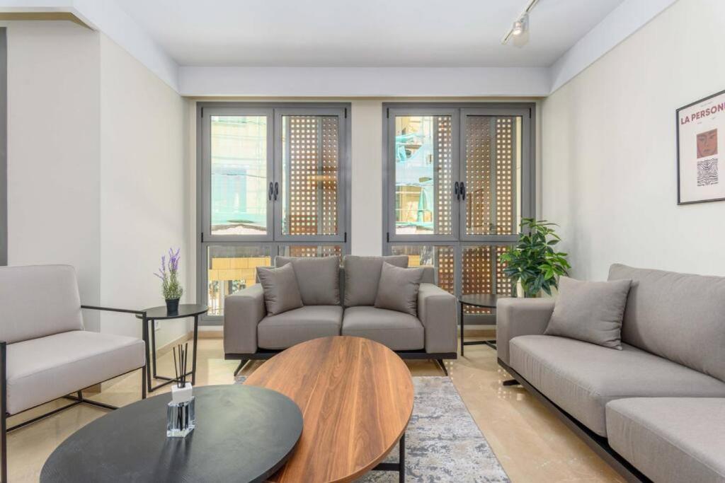 a living room with couches and a table at Symphony 1 Bedroom Apartment in Solidere in Beirut