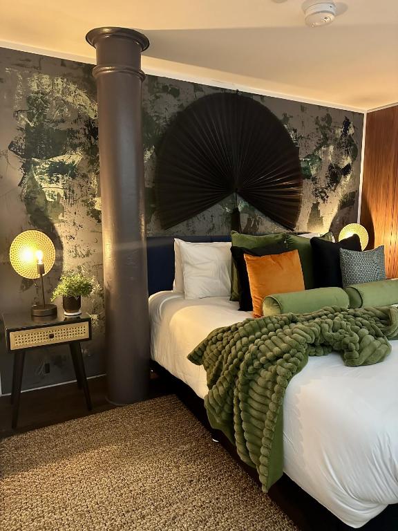 a bedroom with two beds and a wall with an asian painting at Suite4SerenityRWY in Plymouth