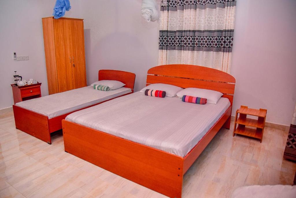 Postel nebo postele na pokoji v ubytování Sinharaja Rest