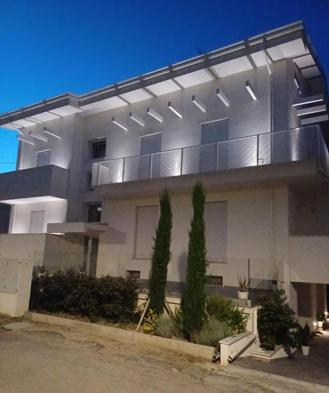 a large building with lights on the side of it at Casa Vacanze Derby Appartamenti in Misano Adriatico