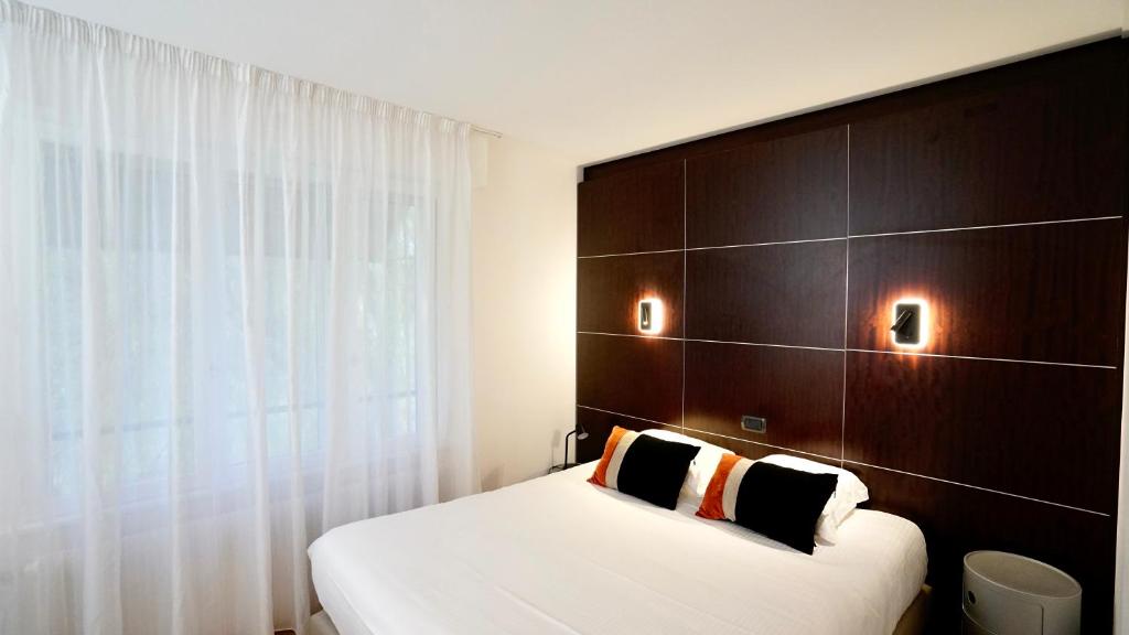 Postel nebo postele na pokoji v ubytování Boutique Logis Hôtel Relais de Vincey