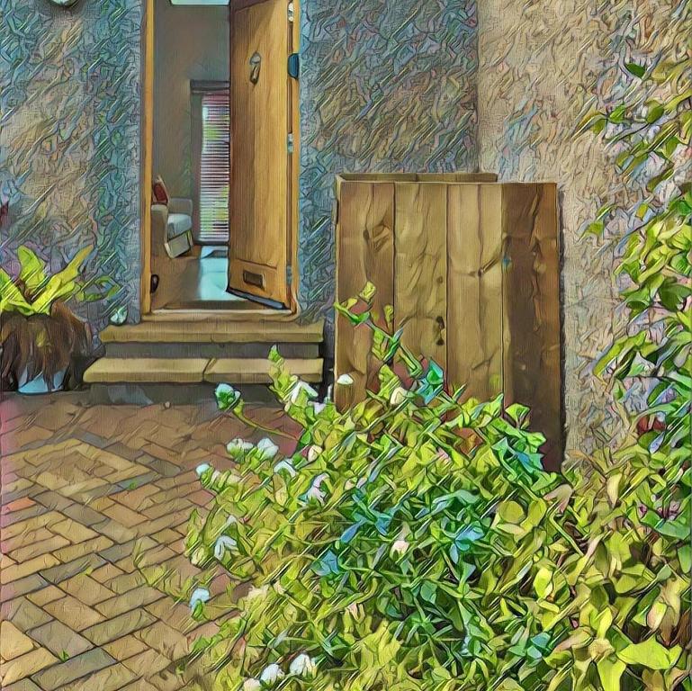 a painting of a house with a door and a bush at Shamerbrea Design Townhouse in Inverness