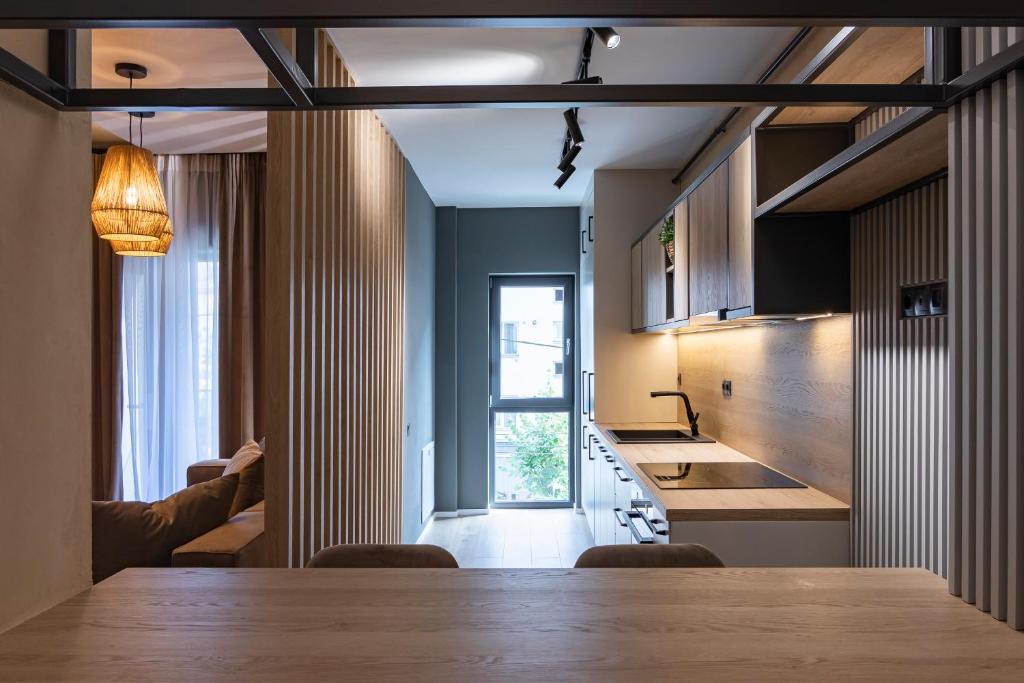 a kitchen with a wooden table and a dining room at Expozitiei ap. 5 in Baia Mare