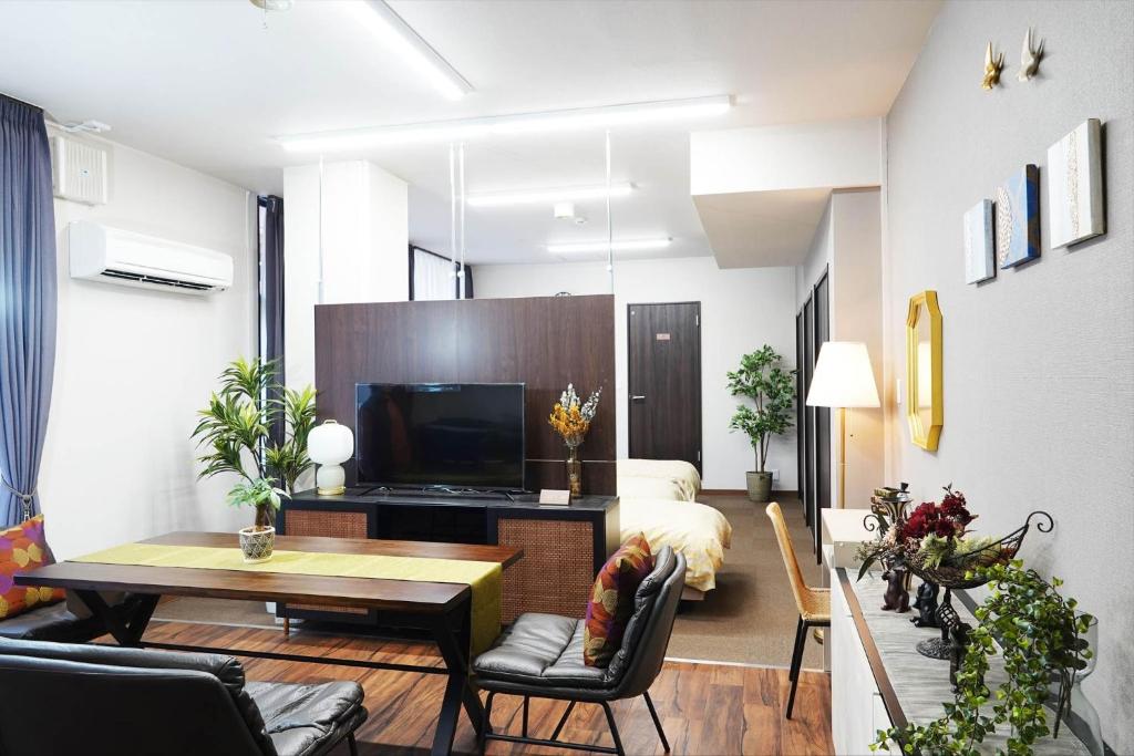 a living room with a couch and a television at THE TORII - Vacation STAY 21195v in Kumamoto