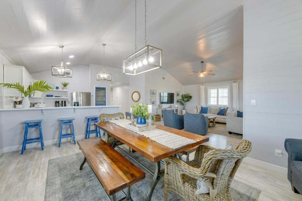 a dining room and living room with a table and chairs at Trendy Beach House with Private Pool and Deck! in Port Aransas