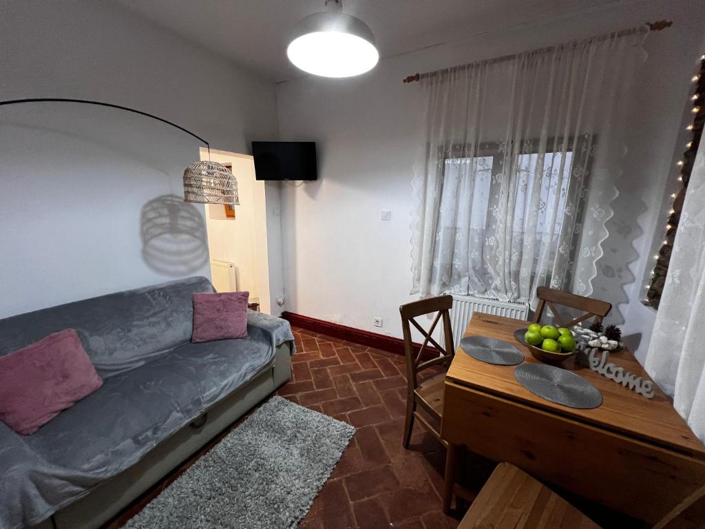 a living room with a couch and a table at Eden Garden in Braşov